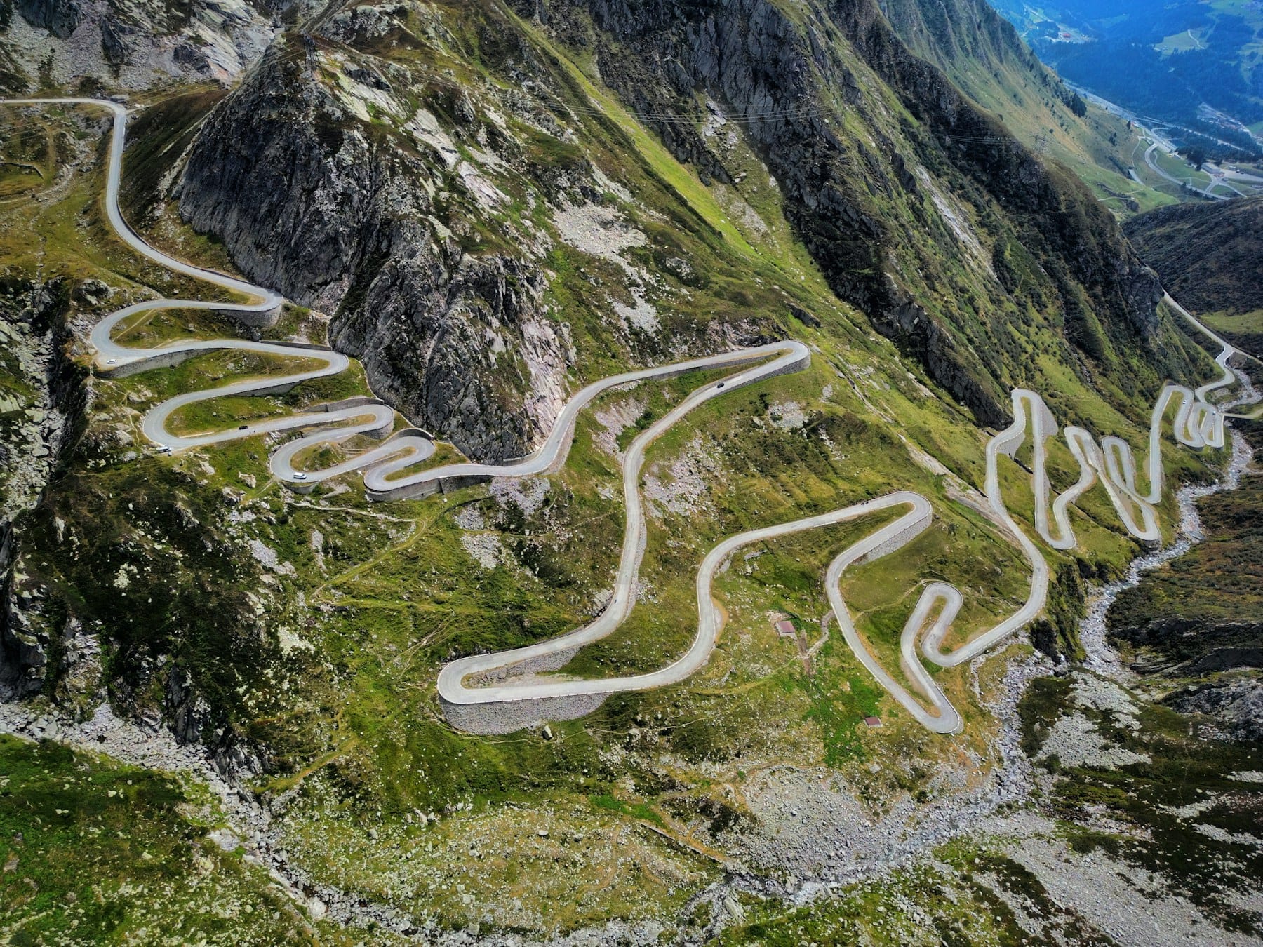 Aerial view of a winding mountain pass road with hairpin turns