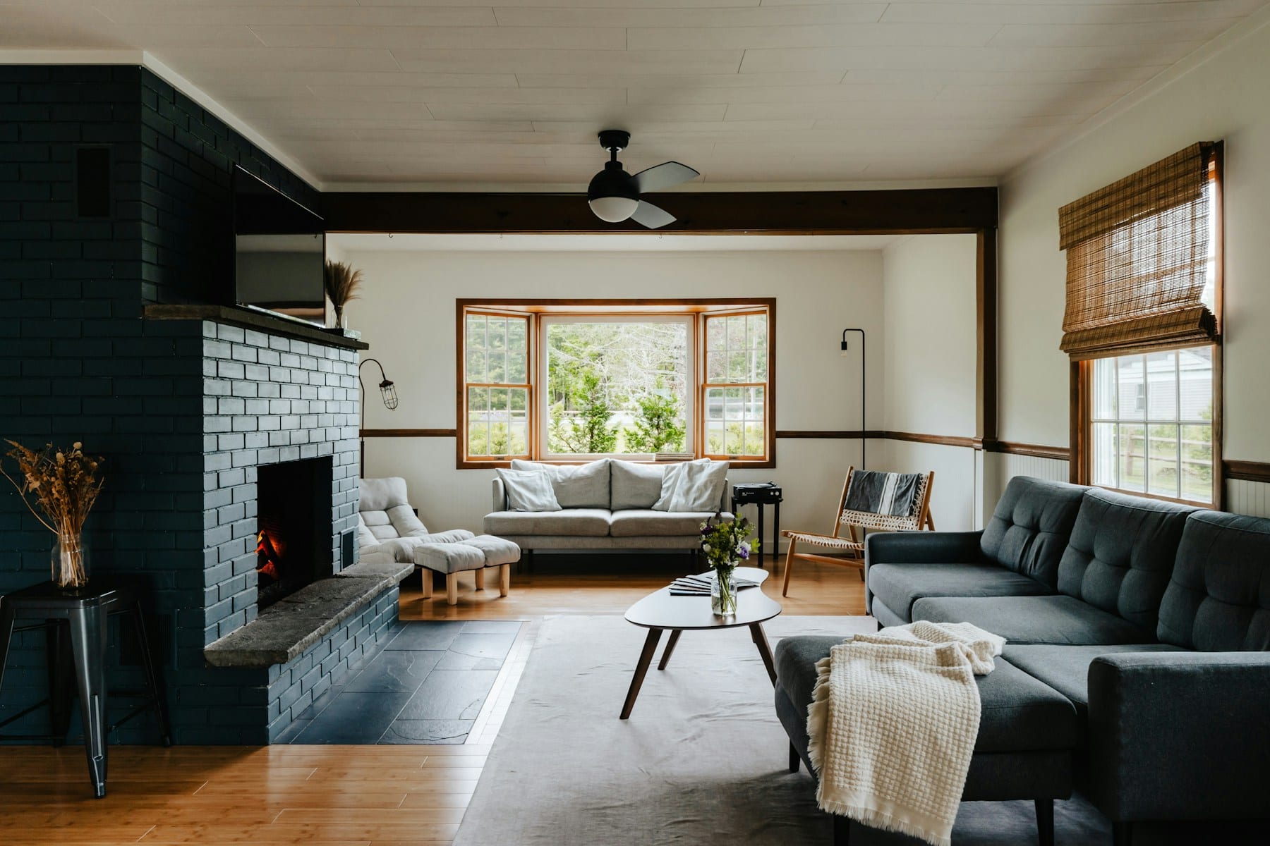 Cosy country-cottage living room with a lit fireplace