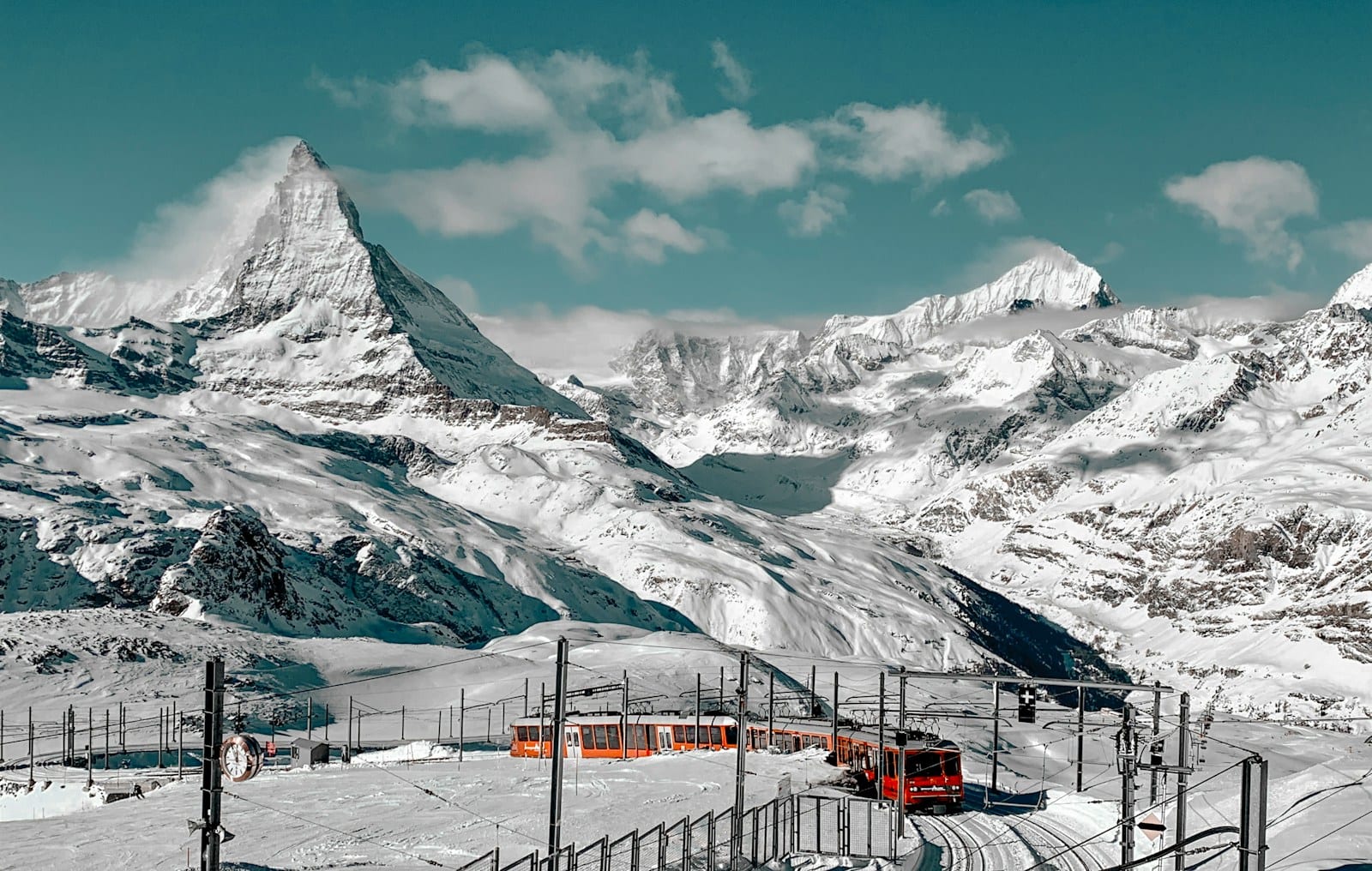The Matterhorn rising above snow-covered Alpine peaks